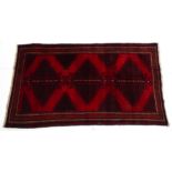 Carpet / Rug: A Persian rug, the red ground with geometric motifs and banded borders. Approx. 86 x