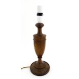 A turned oak table lamp. Approx. 14 1/2" high Please Note - we do not make reference to the
