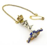 Militaria : a 9ct gold brooch with enamel detail formed as the insignia of the Royal Corps of