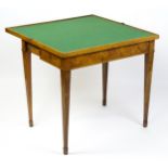 A late 19thC card table with a burr walnut and birds eye maple top separated by satinwood stringing,