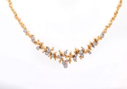 GILBERT ALBERT - Collier en or jaune formé d'une multitude de boules d'or et 24 diamants au centre