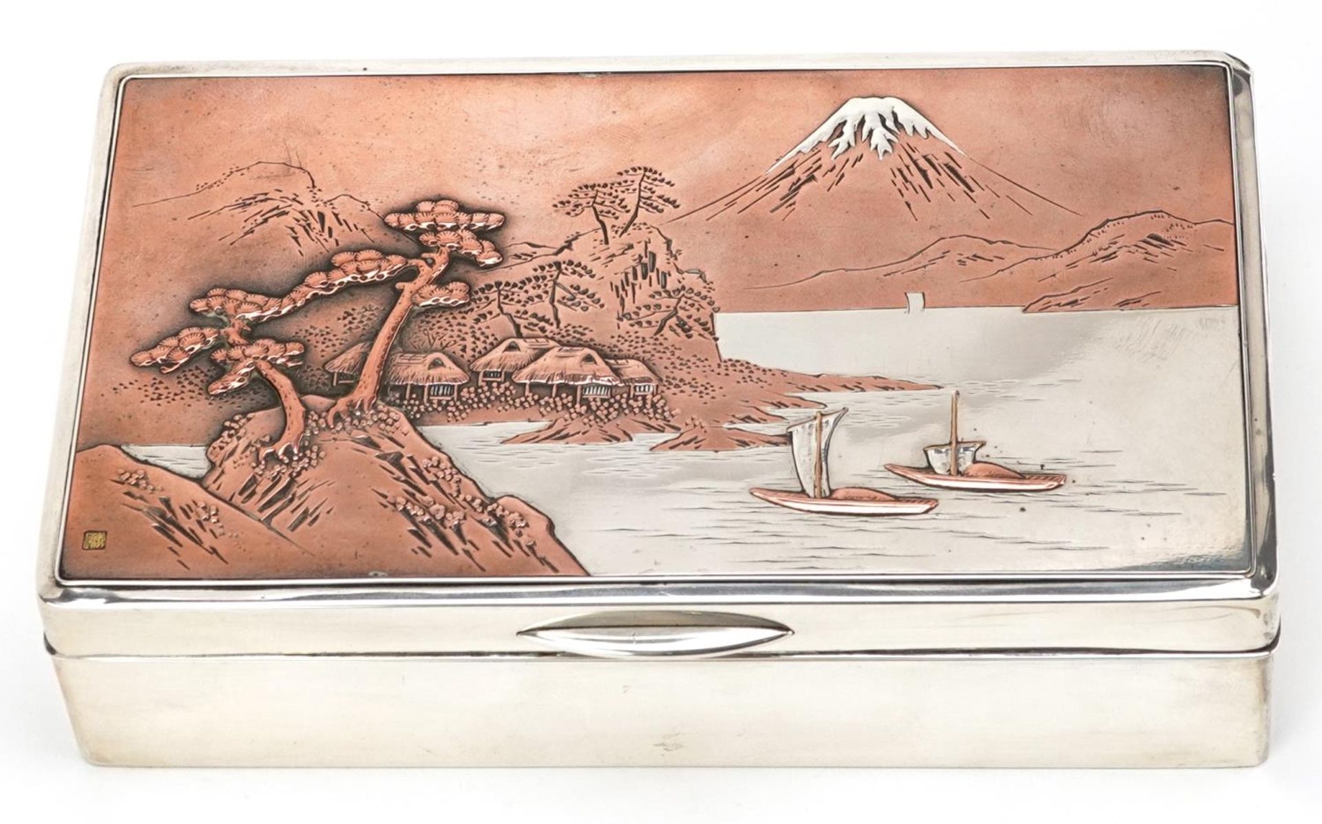 A Japanese silver cigar box, the hinged lid decorated with a view of Mount Fuji, impressed marks