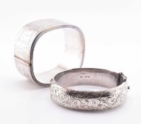 TWO SILVER ENGRAVED HINGED BANGLES