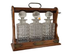 EARLY 20TH CENTURY OAK & CUT GLASS TANTALUS DECANTER