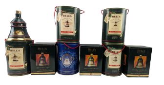 NINE PORCELAIN BELL'S WHISKY COMMEMORATIVE DECANTERS