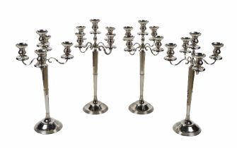 A set of four - five branch silver plated tall Candelabra, on hexagonal reeded column with
