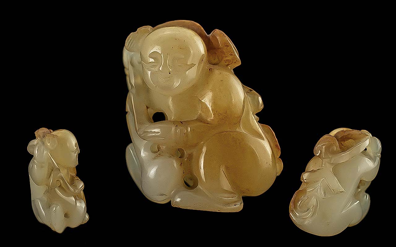Chinese 19th Century Carved Jade Netsuke Figure of a Young Boy Holding an Object Over His Head.