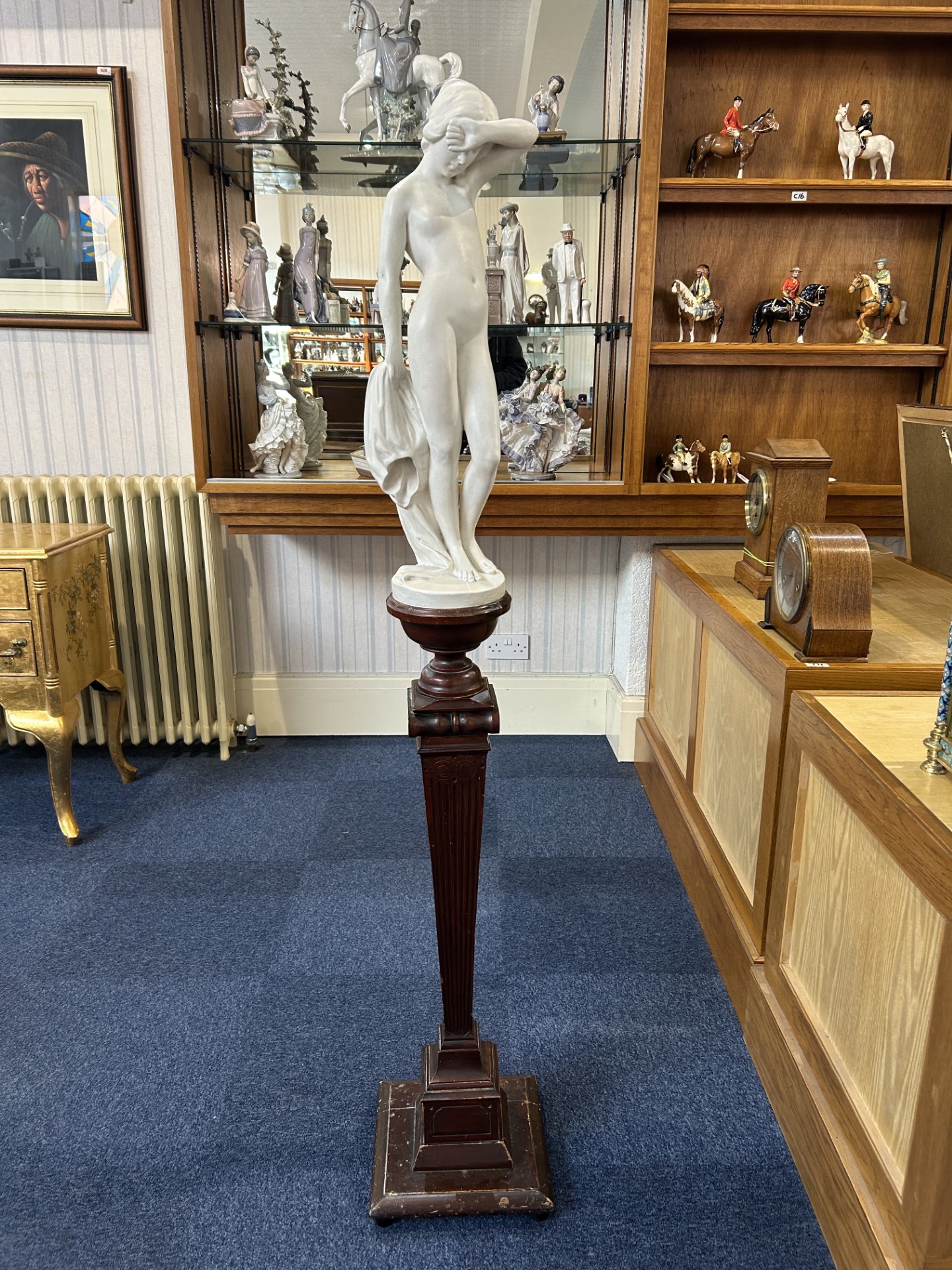 Alabaster Nude Figure of Aphrodite, mounted on a tall stepped dark wooden pedestal. Measures 62''
