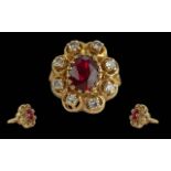 Ladies 18ct Gold Ruby and Diamond Set Cluster Ring. Marked 18ct to Interior of Shank. The Central