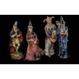 Four Royal Doulton Figures, comprising 'The Pied Piper' HN2102, 'The Wizard' HN2877, 'Witch' HN4444,
