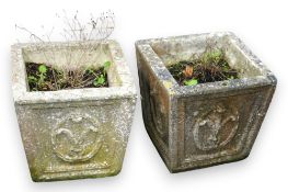 A pair of square tapered reconstituted stone garden planters, moulded with fleur de lys motifs,