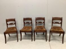 A set of four Regency mahogany dining chairs with sabre legs and roundel spars. Condition - poor