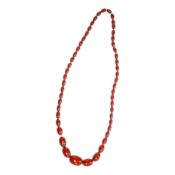 A single strand graduated simulated cherry amber oval bead necklace, 70cm, gross weight 51 grams.