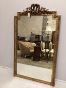 A 19th century French giltwood and composition overmantle mirror with ribbon tied leaf pediment,