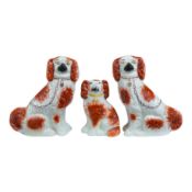 A pair of Staffordshire potter spaniels, and a similar smaller example, taller 18cm. Condition -