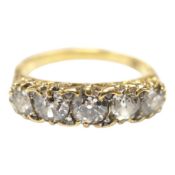 An early 20th century 18ct and graduated five stone diamond set half hoop ring, with rose cut