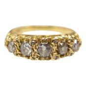 A modern Victorian style 18ct gold and graduated five stone diamond set half hoop ring, with rose