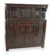A 17th century and later oak court cupboard, with later carved decoration, two panelled upper