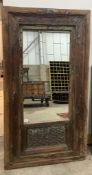 An Indian rectangular carved hardwood wall mirror, width 88cm, height 160cm and a smaller