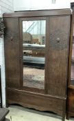 An early 20th century oak mirrored wardrobe, width 124cm, depth 42cm, height 188cm. Condition -