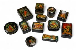 A quantity of Russian lacquer boxes decorated with figures and mythical scenes, largest 10cm in