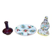 A Japanese porcelain seated figure of Kwannon, a flambé vase and a figural saucer dish, saucer