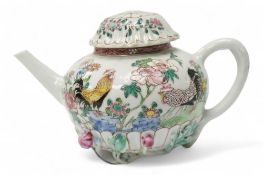 A Chinese famille rose chrysanthemum moulded teapot, early Qianlong period, painted with a