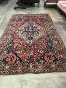 A North West Persian brick red ground carpet, 320 x 178cm. Condition - poor to fair