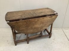 A small late 17th century oak oval topped gate leg table, width 100cm, depth 45cm, height 70cm.