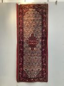 A North West Persian ivory ground rug, 192 x 78cm. Condition - fair