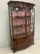 An Edwardian Sheraton style mahogany bow front display cabinet, width 126cm, depth 40cm, height