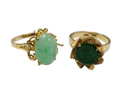 A Chinese 14k and single stone oval cabochon jadeite set ring, size P and a similar 14k and