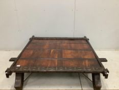 An Indian hardwood and iron mounted low square table, width 138cm, depth 130cm, height 33cm.