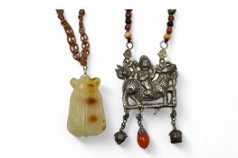 A Chinese celadon and russet jade cicada pendant on cording and a silver and stone mounted chain and