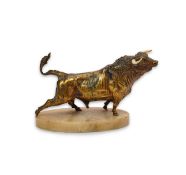 An early 20th century French gilt bronze model of a roaring bull, with ivory horns, on alabaster