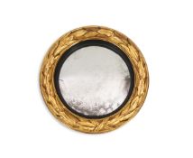 A Regency giltwood convex wall mirror with reeded ebonised slip and acanthus carved frame,