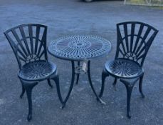 An aluminium garden table, diameter 65cm and a pair of chairs. Condition - poor