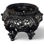 A small Chinese ornate wooden stand with carved apron, 8.5cm diameter. Condition - good