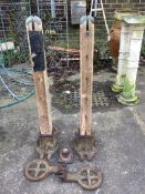 A pair of Victorian cast iron and hardwood tennis posts with ground anchors, height 109cm. Condition