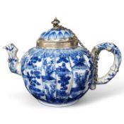 A Chinese blue and white teapot, Kangxi with white metal mounting. 12cm high. Condition - restored