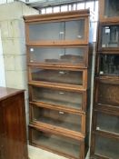 A Globe Wernicke oak six section bookcase, lacks plinth base, width 86cm, depth 25cm, height 186cm.