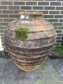 A Greek style terracotta oil jar, height 93cm. Condition - fair