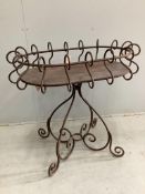 A wrought iron oval centre table, width 88cm, depth 60cm, height 82cm. Condition - fair to good