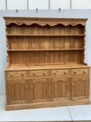 A Victorian style pine dresser with boarded rack, width 198cm, depth 52cm, height 207cm. Condition -