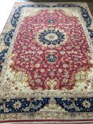 A Tabriz burgundy ground carpet, 300 x 200cm. Condition - fair