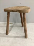 Robert Thompson, 'The Mouseman', a carved oak three legged stool, width 36cm, depth 32cm, height