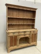 A 19th century and later pine dresser with boarded rack, width 154cm, depth 44cm, height 192cm.