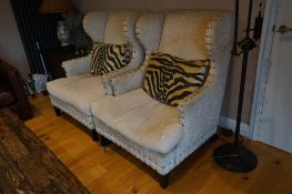 A pair of Martin Fleming armchairs with zebra cushions, width 85cm, depth 80cm, height 112cm.
