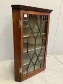 A George III oak hanging corner cabinet, width 66cm, depth 38cm, height 103cm. Condition - fair, loc