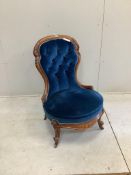 A Victorian carved walnut frame spoonback nursing chair on cabriole legs, recently re-upholstered in